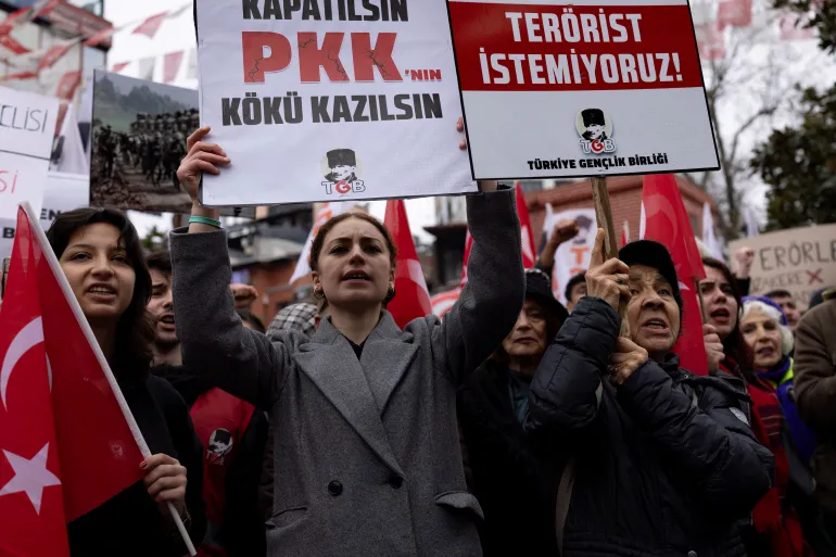 Pessoas turcas se reúnem para protestar contra os esforços do governo para encerrar o conflito de 40 anos com o PKK, em Istambul, Turquia, 16 de fevereiro de 2025 [Umit Bektas/Reuters] (Reuters). Fonte: Al Jazeera