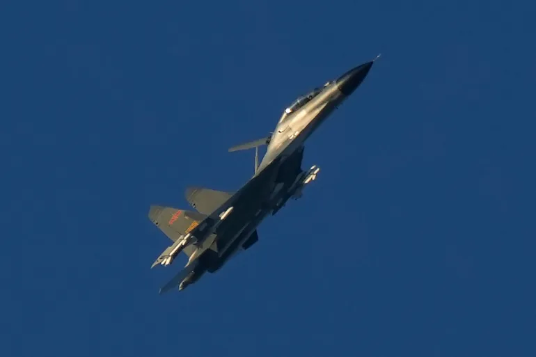 Um caça militar chinês J-11 voa sobre o Estreito de Taiwan, perto de Pingtan, a terra mais próxima da China continental à ilha de Taiwan. [Arquivo: Ng Han Guan/AP Photo] Fonte: Al Jazeera