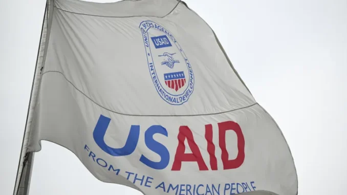 Uma bandeira ondula na sede da Agência dos Estados Unidos para o Desenvolvimento Internacional (USAID) em Washington, DC, Estados Unidos, em 3 de fevereiro de 2025 [Celal Gunes/Anadolu via Getty Images]. Fonte: Al Jazeera