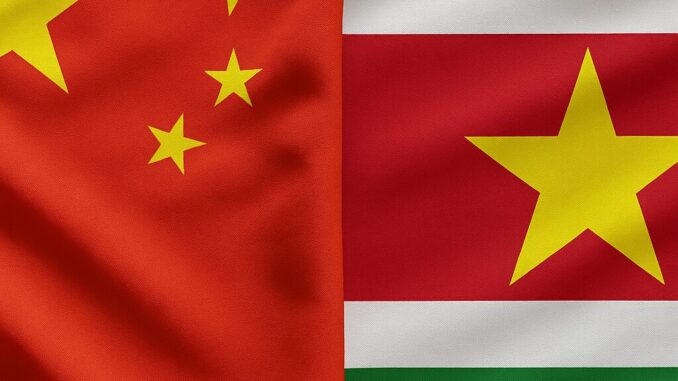 china-suriname-relacao-estrategica Paisagem diplomática: bandeiras da China e do Suriname lado a lado em frente a uma construção governamental.