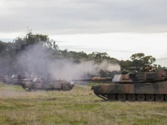 Soldado do Exército Australiano dispara metralhadora pesada .50 a partir de um tanque M1A1 Abrams durante exercício militar em Victoria, Austrália.