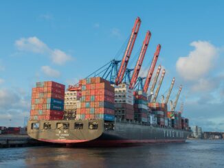 Navio cargueiro com containers no porto, representando exportações internacionais do Brasil