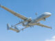 Drone Heron MK II da Israel Aerospace Industries voando em céu azul durante missão de longa duração.