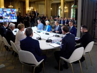 Líderes europeus, incluindo Emmanuel Macron e Ursula von der Leyen, reunidos em torno de mesa durante cimeira em Paris, com participação de Volodymyr Zelensky e representantes internacionais, discutindo apoio à Ucrânia.